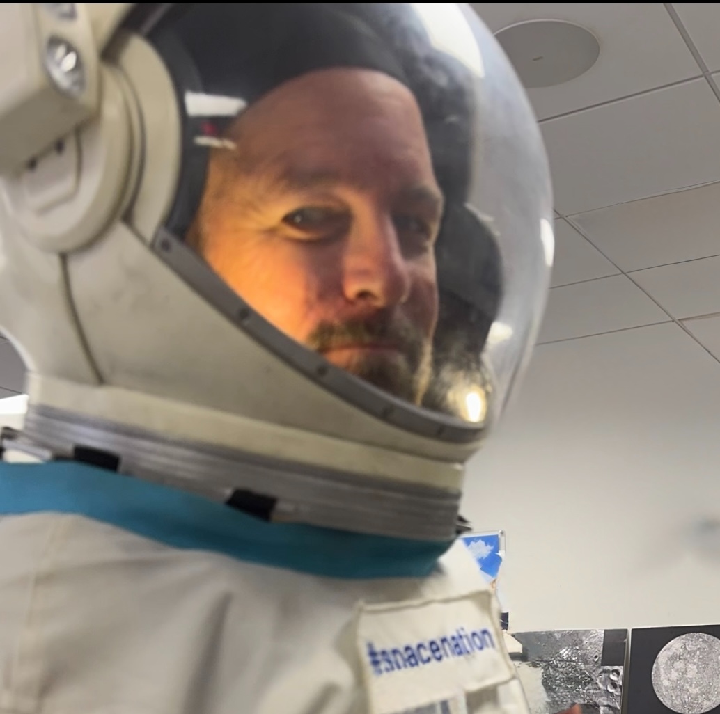 Ray Myers in a full pressure suit and helmet during astronaut training