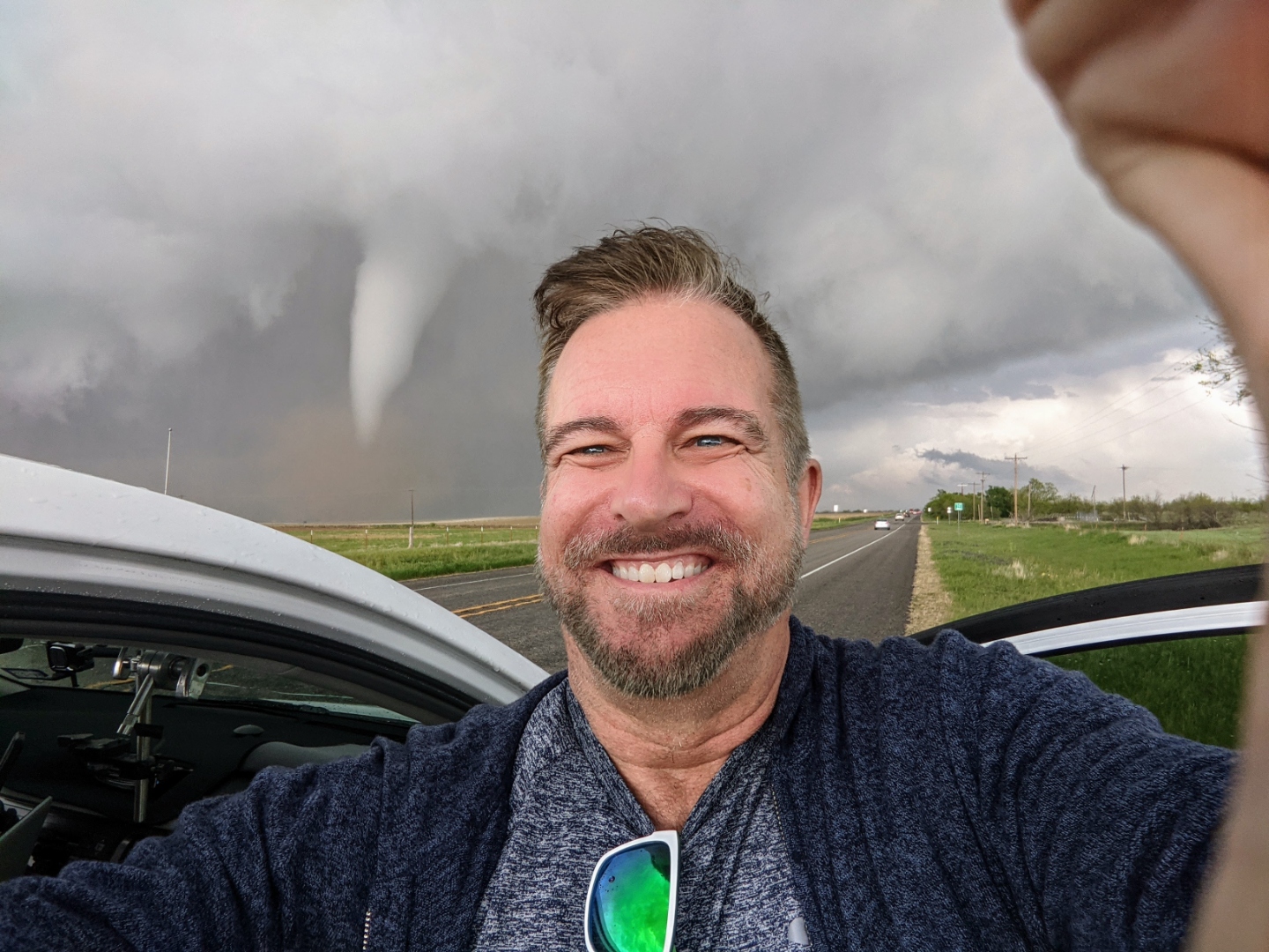 Ray Myers in the Texas Panhandle with a tornado dropping behind him